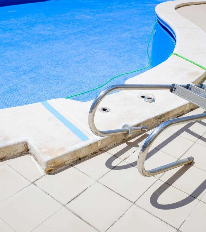 Cleaning an empty swimming pool in a residential